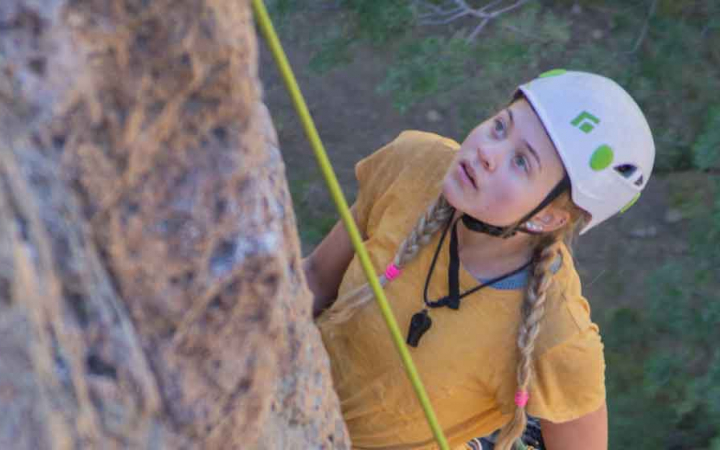 girls observes rock wall on expedition with outward bound